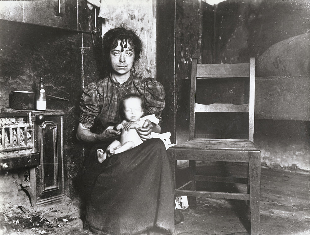 A Glasgow woman and baby in slum. c. 1910